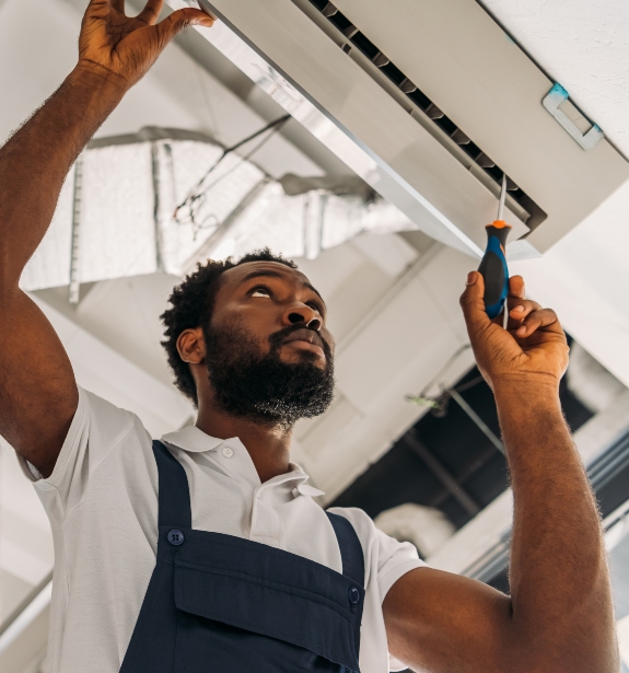 low angle view of african american handyman repair CBF4W7A 1